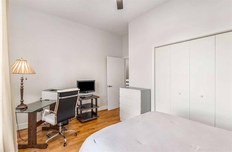 384 Ralph McGill Boulevard Northeast, Unit 313 Atlanta, GA 30312 - Photo 21 of 31 a bedroom with a bed a desk and chair