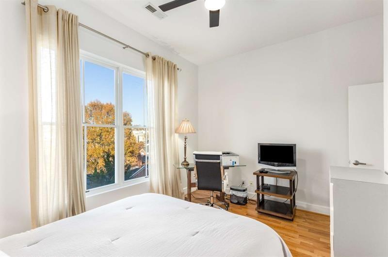 384 Ralph McGill Boulevard Northeast, Unit 313 Atlanta, GA 30312 - Photo 22 of 31 a bedroom with a bed and a window