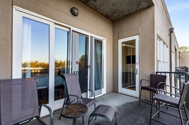 a view of a balcony with chair and table