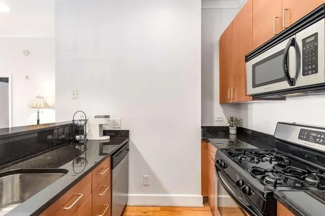 a kitchen with granite countertop cabinets and stainless steel appliances