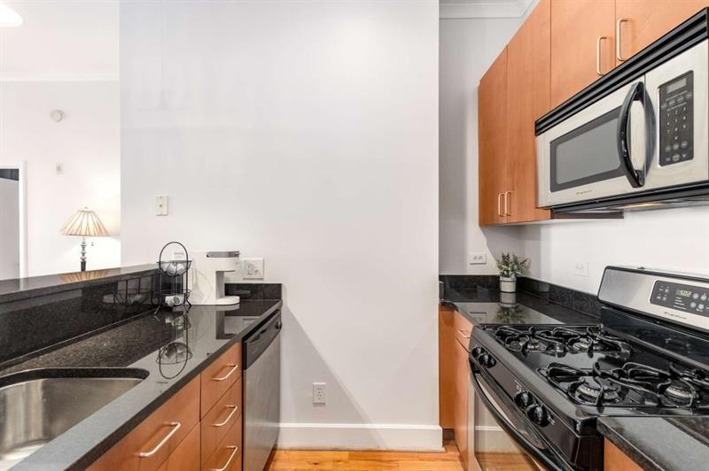 384 Ralph McGill Boulevard Northeast, Unit 313 Atlanta, GA 30312 - Photo 8 of 31 a kitchen with granite countertop a stove and a sink
