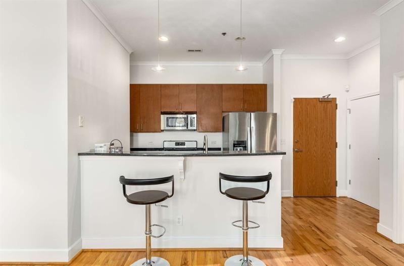 384 Ralph McGill Boulevard Northeast, Unit 313 Atlanta, GA 30312 - Photo 10 of 31 a kitchen with stainless steel appliances granite countertop a sink and a refrigerator