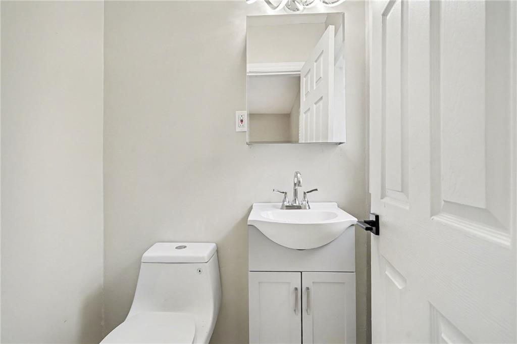 2912 Belvedere Lane Decatur, GA 30032 - Photo 11 of 25 a bathroom with a toilet a sink and mirror