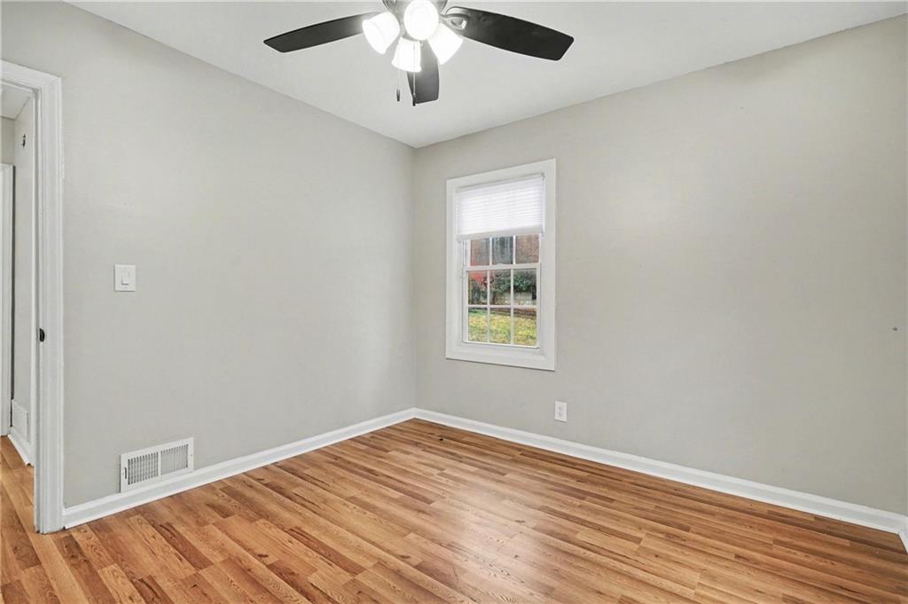 2912 Belvedere Lane Decatur, GA 30032 - Photo 18 of 25 wooden floor in an empty room with a window
