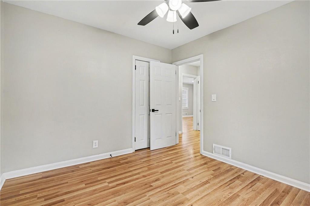 2912 Belvedere Lane Decatur, GA 30032 - Photo 19 of 25 a view of an empty room with wooden floor and a ceiling fan