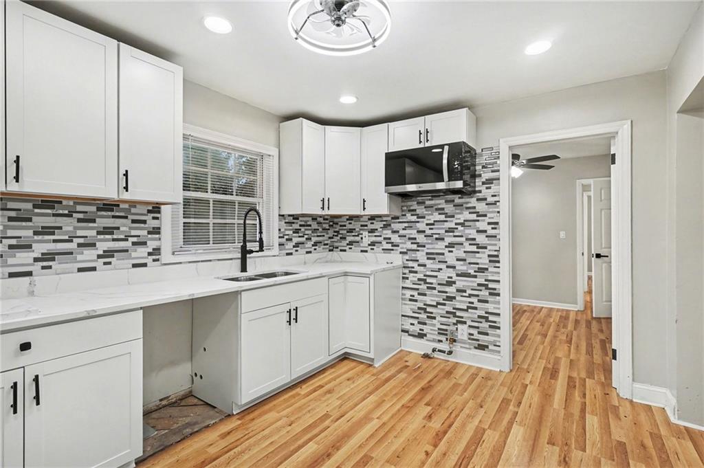 2912 Belvedere Lane Decatur, GA 30032 - Photo 9 of 25 a kitchen with sink cabinets and microwave