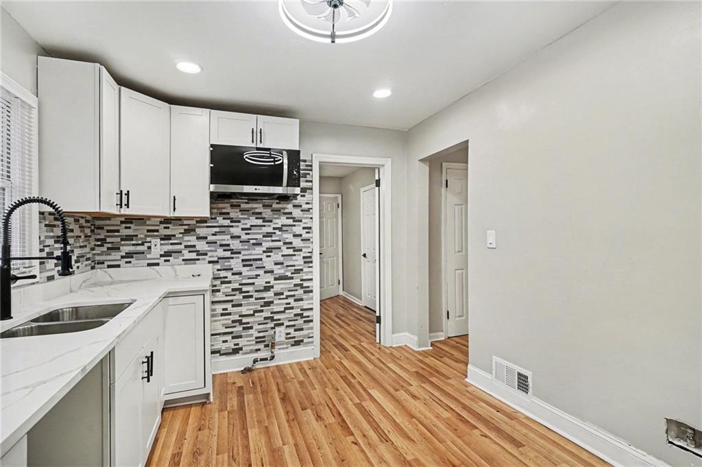 2912 Belvedere Lane Decatur, GA 30032 - Photo 10 of 25 a kitchen with sink a microwave a stove and refrigerator