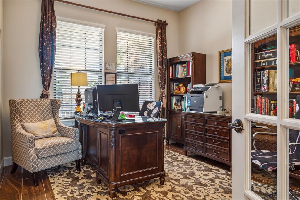 8530 Grand Alberato Road Tampa, FL 33647 - Photo 11 of 67 a view of a workspace with furniture and a window