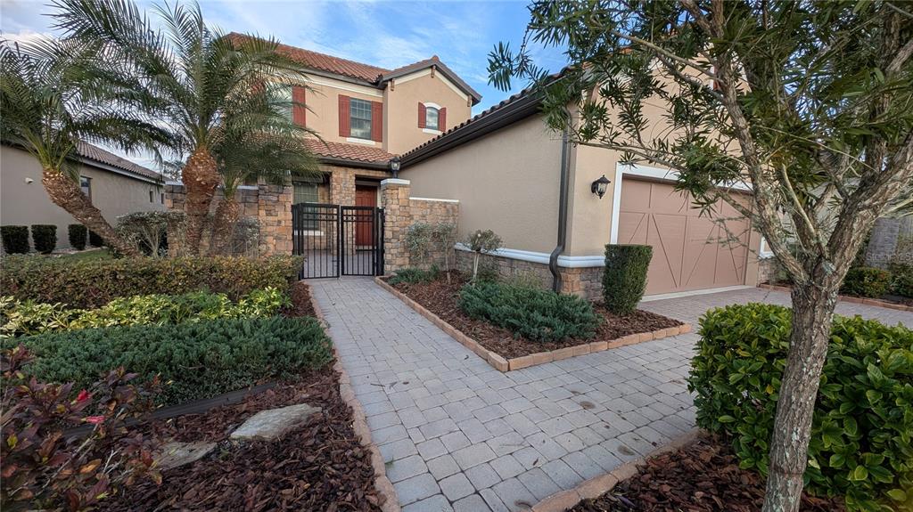 8530 Grand Alberato Road Tampa, FL 33647 - Photo 2 of 67 a front view of a house with garden
