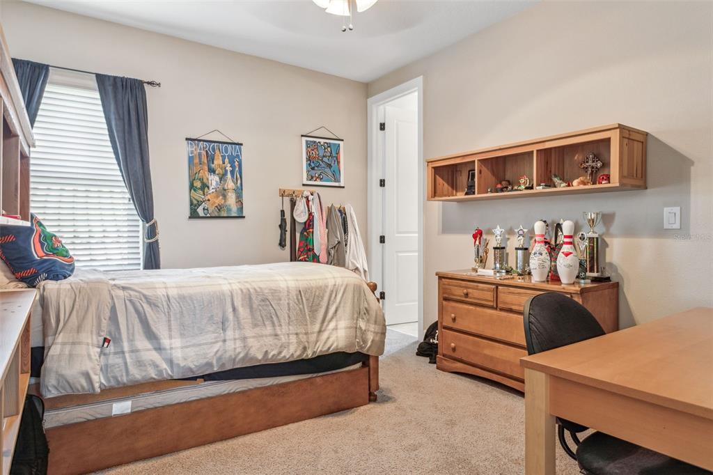 8530 Grand Alberato Road Tampa, FL 33647 - Photo 24 of 67 a bedroom with a bed and a desk