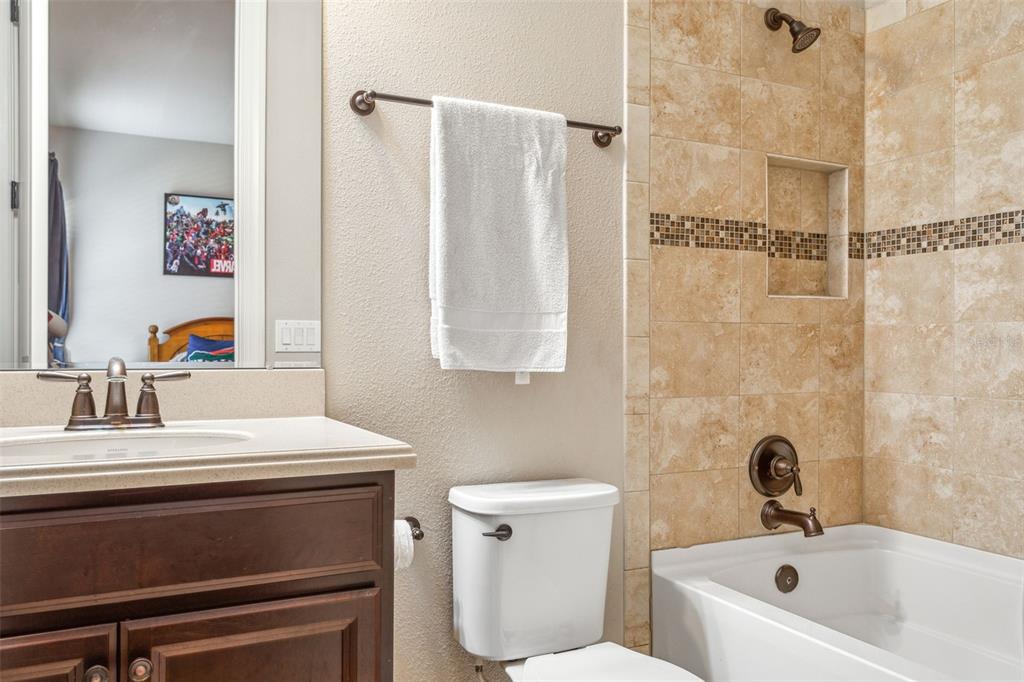8530 Grand Alberato Road Tampa, FL 33647 - Photo 25 of 67 a bathroom with a sink a toilet and a bathtub