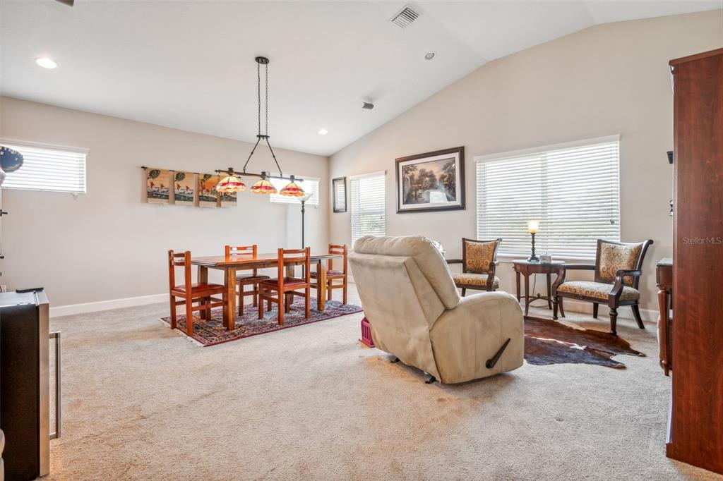 8530 Grand Alberato Road Tampa, FL 33647 - Photo 28 of 67 a living room with furniture and a chandelier