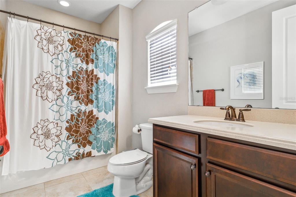 8530 Grand Alberato Road Tampa, FL 33647 - Photo 32 of 67 a bathroom with a granite countertop sink toilet and mirror