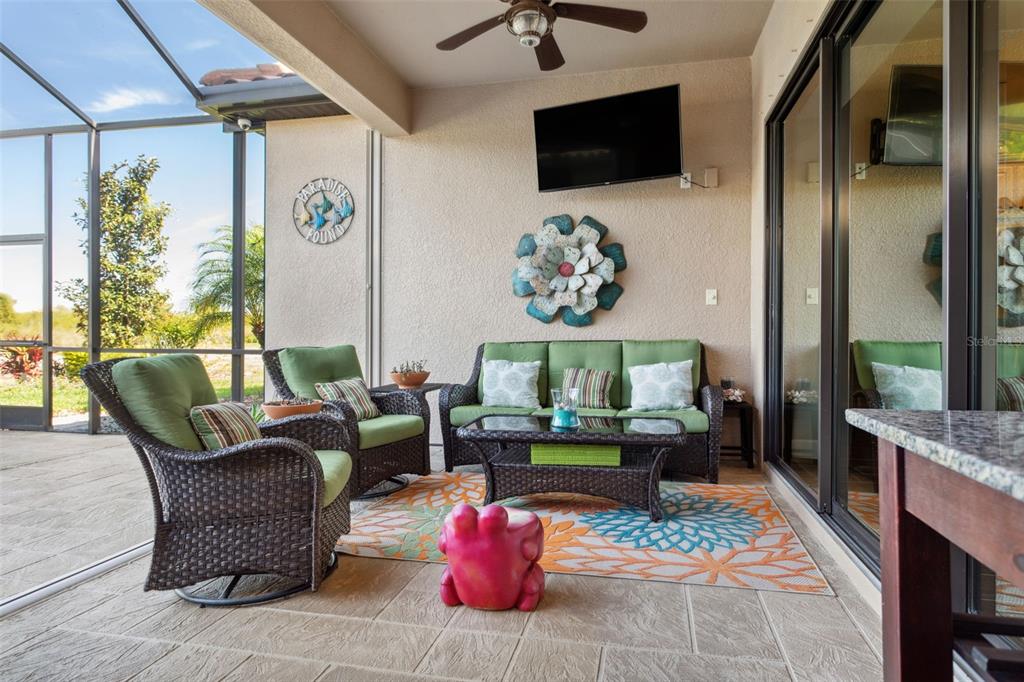 8530 Grand Alberato Road Tampa, FL 33647 - Photo 44 of 67 a living room with furniture and a flat screen tv