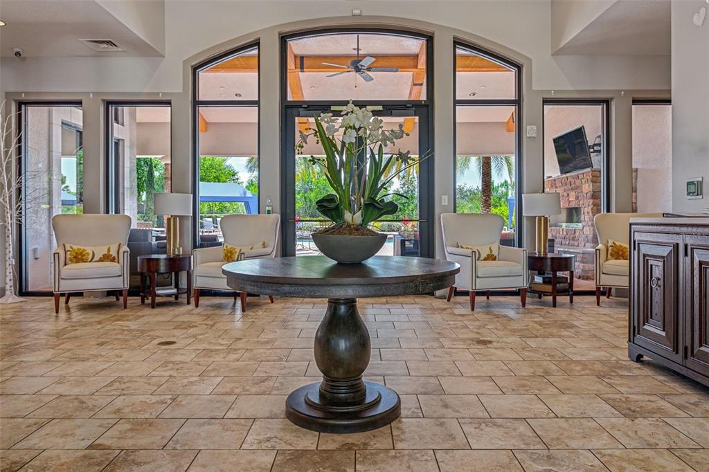 8530 Grand Alberato Road Tampa, FL 33647 - Photo 59 of 67 a living room with fireplace furniture and a floor to ceiling window