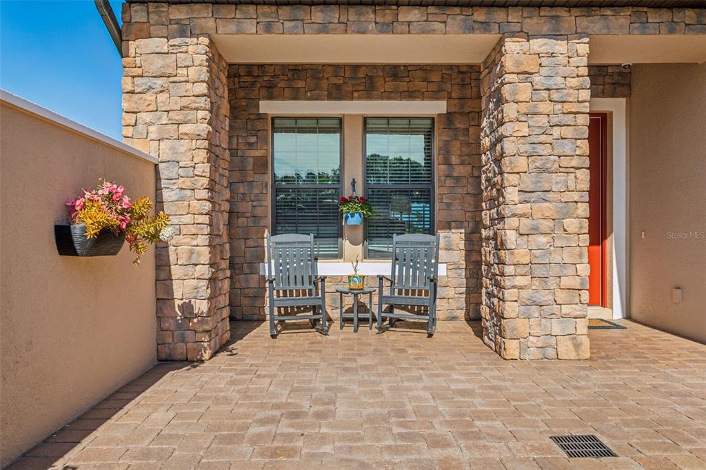 8530 Grand Alberato Road Tampa, FL 33647 - Photo 6 of 67 a view of a porch with a table and chairs