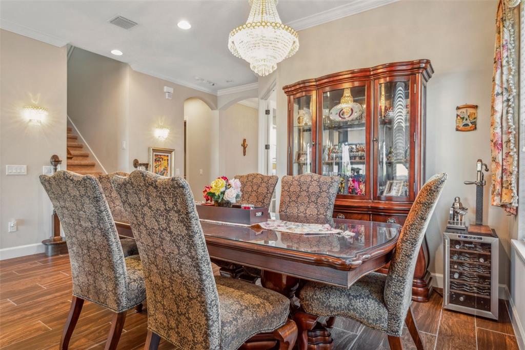 8530 Grand Alberato Road Tampa, FL 33647 - Photo 10 of 67 a view of a dining room with furniture and wooden floor