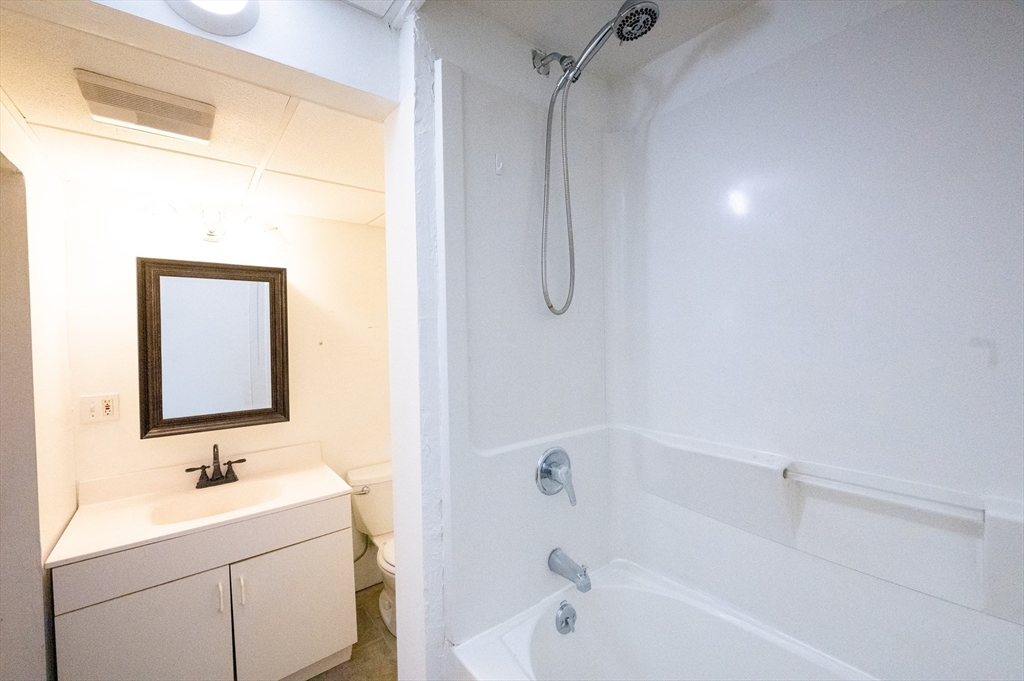 15 Cumberland Street Worcester, MA 01606 - Photo 23 of 35 a bathroom with a sink a toilet and shower