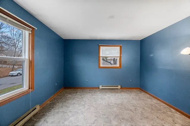 a spacious bedroom with a bed and window