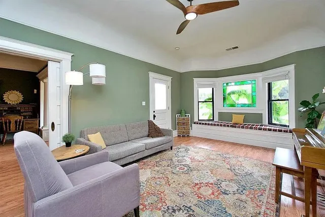 a living room with furniture and a large window