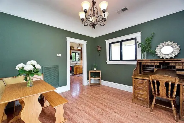a living room with furniture a chandelier and a window