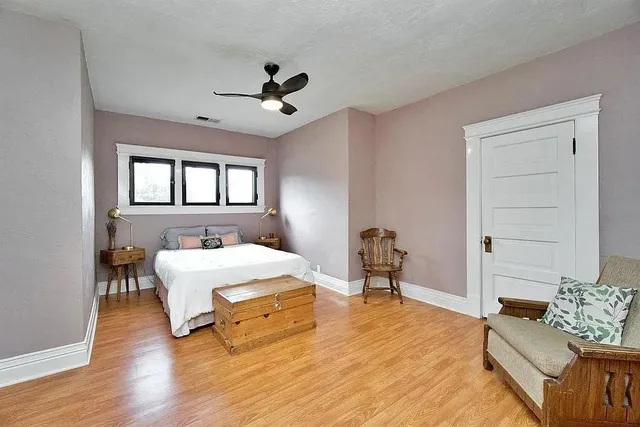 a bedroom with a bed and a chandelier