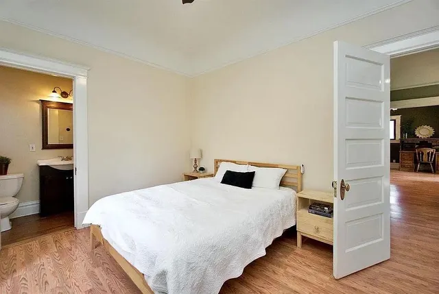 a bedroom with a bed and a table