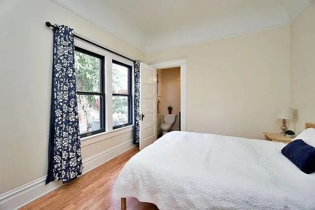 a bedroom with a large bed and a large window