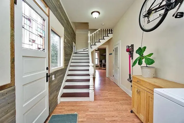 a hallway with wooden floor and windows