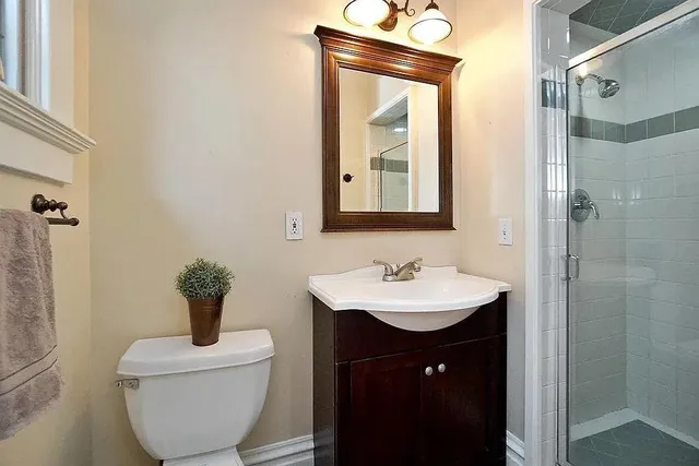 a bathroom with a toilet sink and mirror