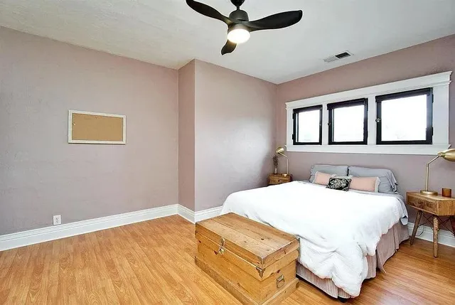 a bedroom with a bed dresser and a window