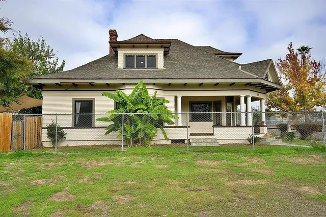a front view of a house with a garden and plants