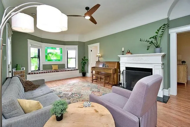 a living room with furniture and a fireplace