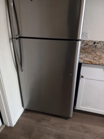 an empty room with wooden floor and bench
