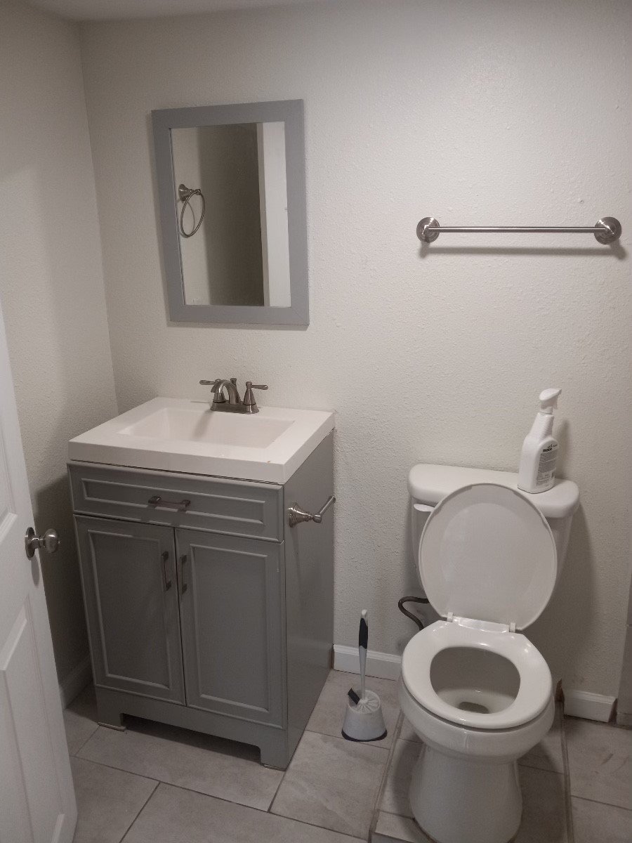 4309 Jack Street, Unit 6 Houston, TX 77006 - Photo 7 of 7 a bathroom with a toilet sink and mirror