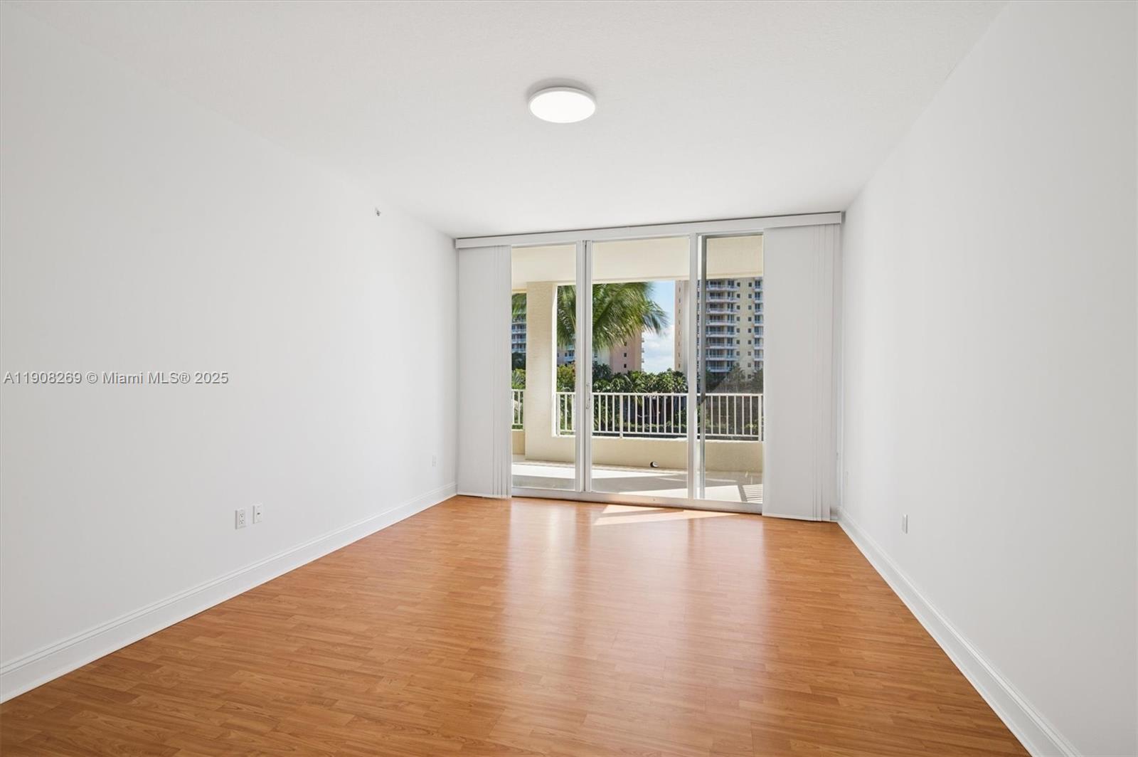 717 Crandon Boulevard, Unit 507 Key Biscayne, FL 33149 - Photo 11 of 27 a view of an empty room with wooden floor and a window