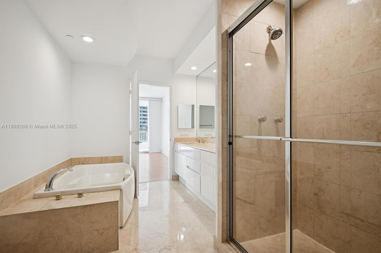 717 Crandon Boulevard, Unit 507 Key Biscayne, FL 33149 - Photo 13 of 27 a bathroom with a granite countertop sink mirror and shower