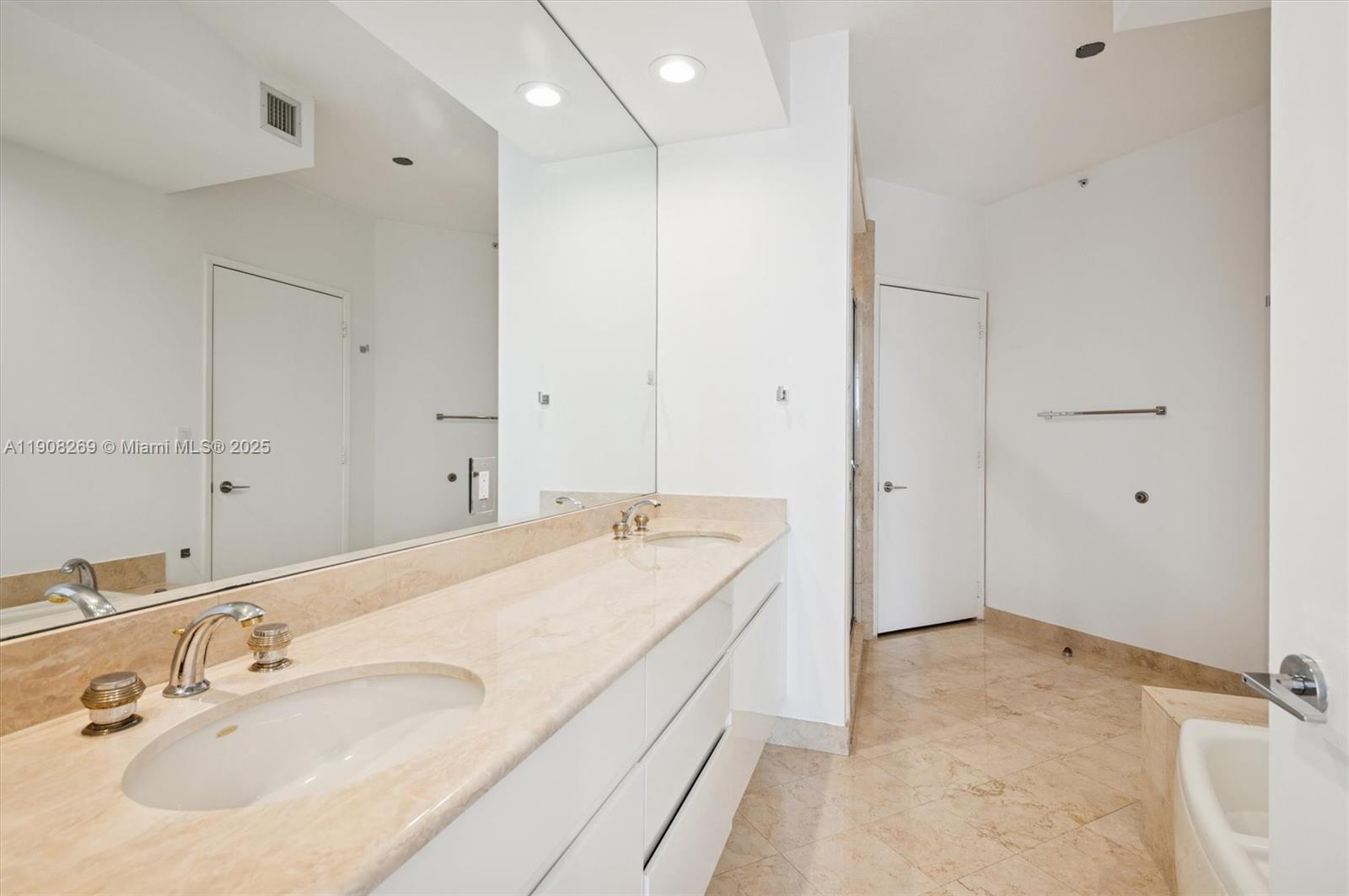 717 Crandon Boulevard, Unit 507 Key Biscayne, FL 33149 - Photo 14 of 27 a spacious bathroom with a granite countertop sink and a mirror
