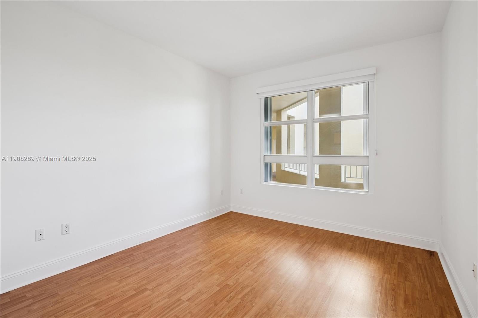 717 Crandon Boulevard, Unit 507 Key Biscayne, FL 33149 - Photo 15 of 27 a view of an empty room with wooden floor and a window