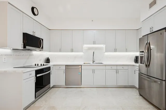 a kitchen with appliances a sink and a stove