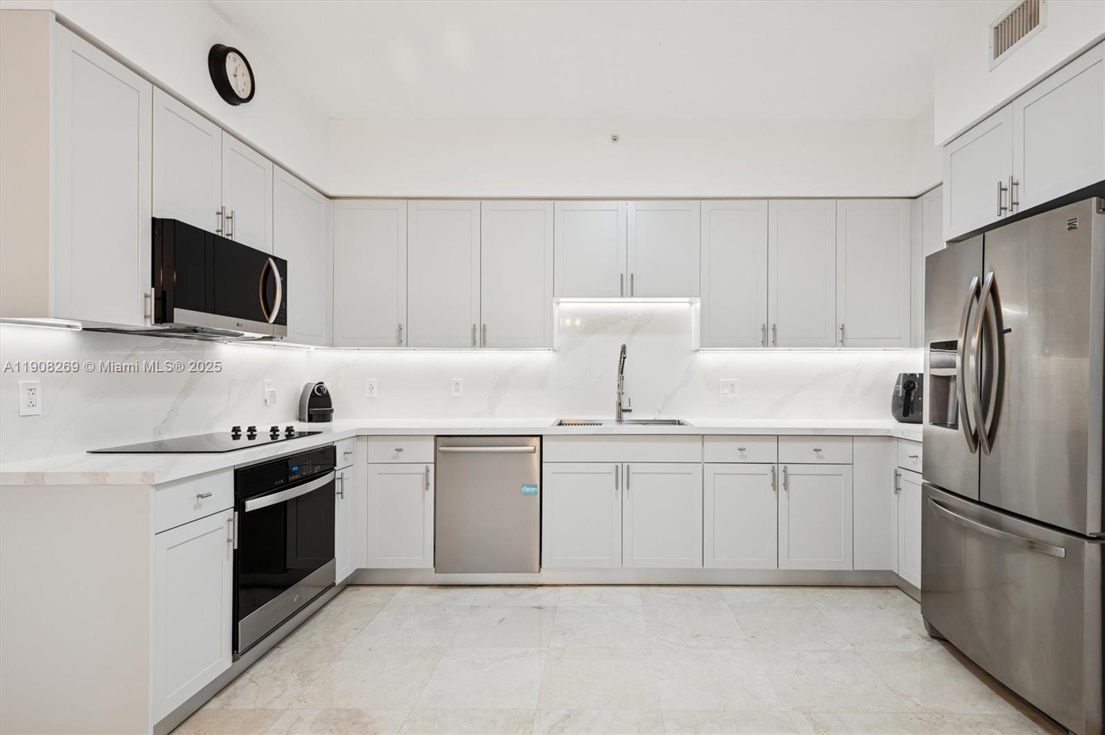 717 Crandon Boulevard, Unit 507 Key Biscayne, FL 33149 - Photo 5 of 27 a kitchen with appliances a sink and a stove