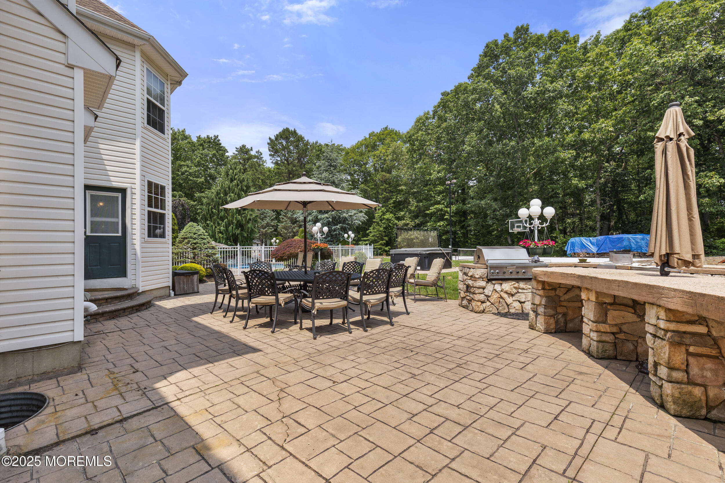 3 Wellesly Court Jackson, NJ 08527 - Photo 6 of 32 a view of the patio with dining table and chairs under an umbrella with a barbeque