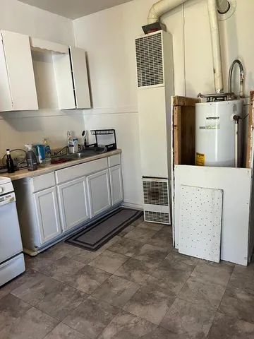 a kitchen with cabinets a sink and a stove