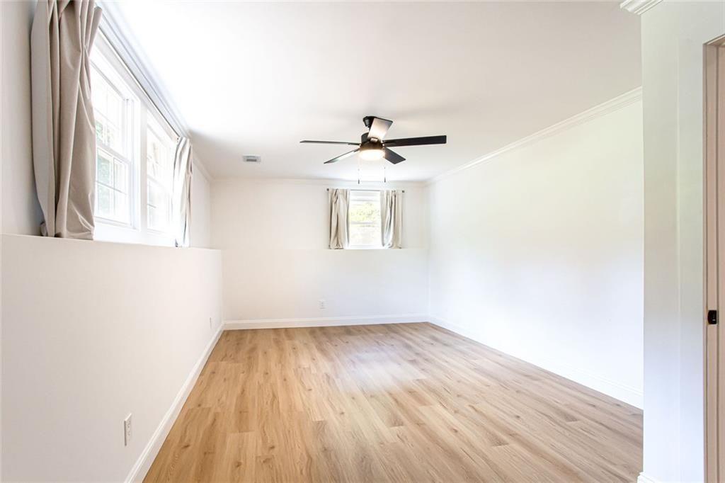 2814 Goodfellows Road Tucker, GA 30084 - Photo 32 of 46 an empty room with a window and wooden floor