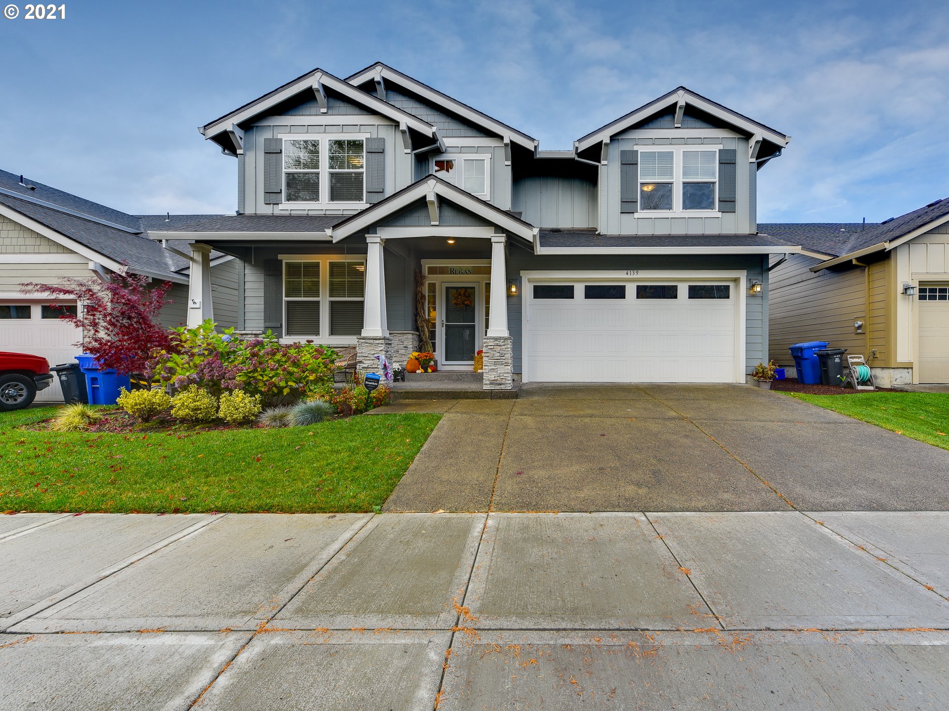 a front view of a house with a yard and garage