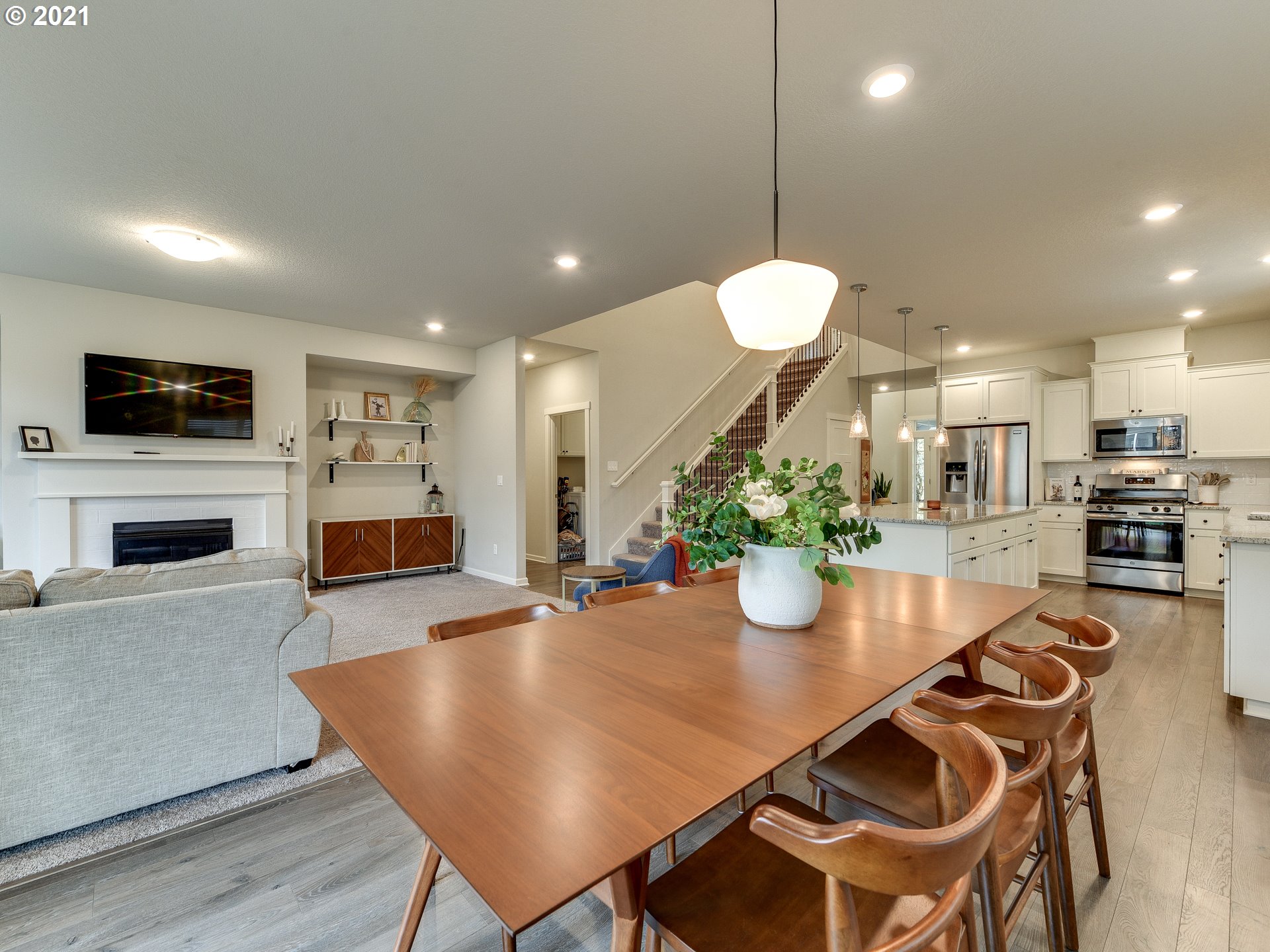 4139 Southwest Rodlun Road Gresham, OR 97080 - Photo 16 of 32 a kitchen with a dining table chairs stainless steel appliances and wooden floor