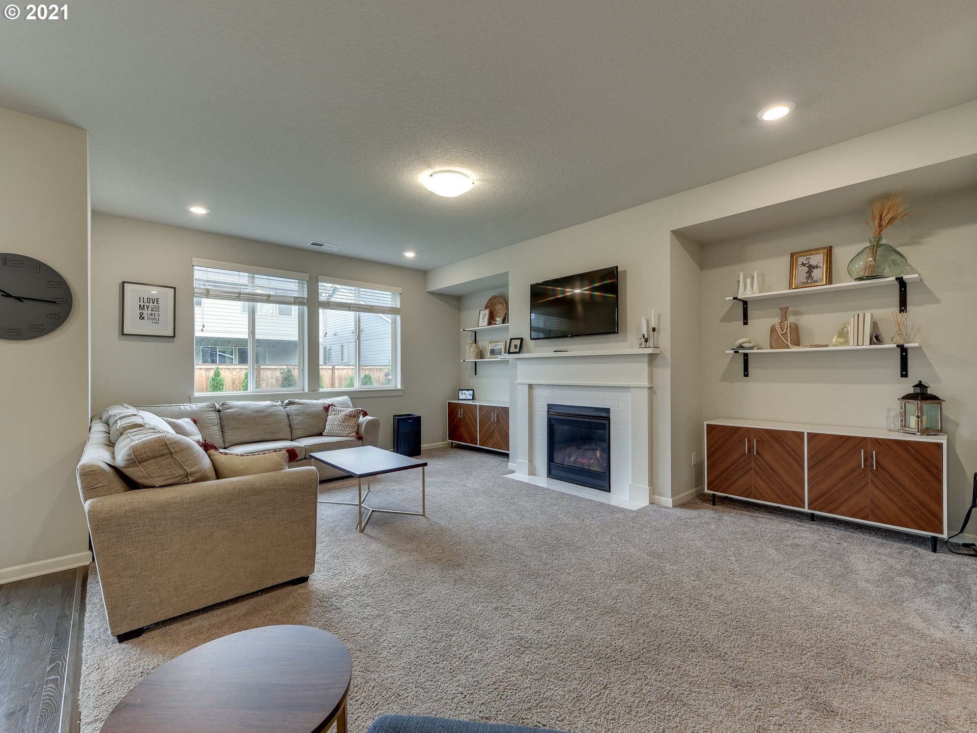 4139 Southwest Rodlun Road Gresham, OR 97080 - Photo 18 of 32 a living room with furniture a fireplace and a flat screen tv