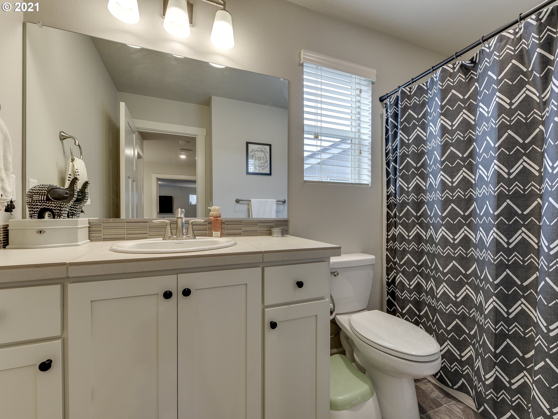 4139 Southwest Rodlun Road Gresham, OR 97080 - Photo 29 of 32 a bathroom with a granite countertop toilet sink and mirror