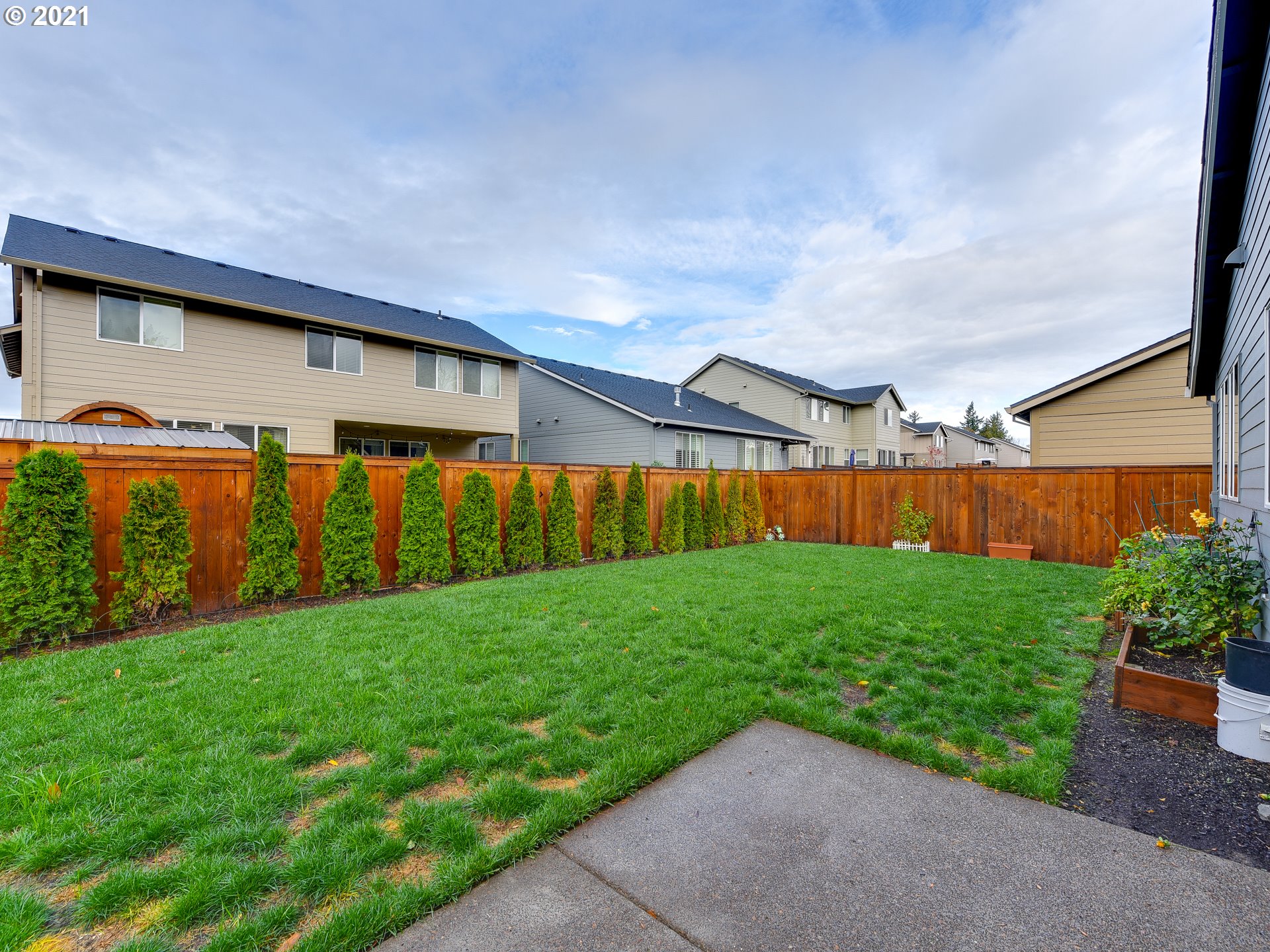 4139 Southwest Rodlun Road Gresham, OR 97080 - Photo 32 of 32 a backyard of a house with lots of green space and outdoor seating