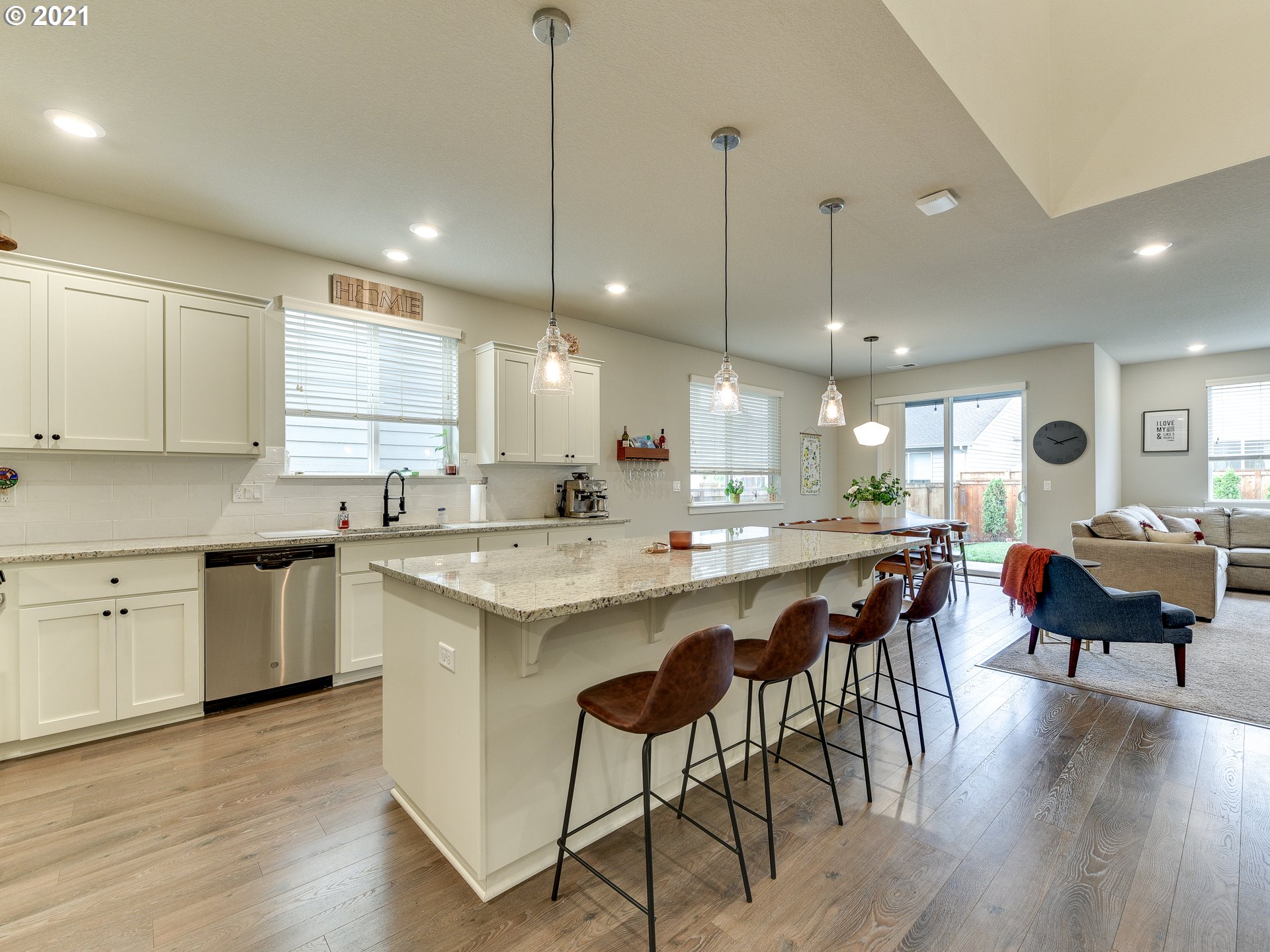 4139 Southwest Rodlun Road Gresham, OR 97080 - Photo 7 of 32 a kitchen with lots of counter space a sink dining table and chairs